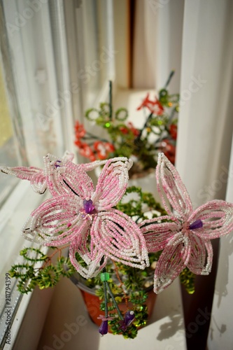 beautiful pink flower of beads on the window-sill