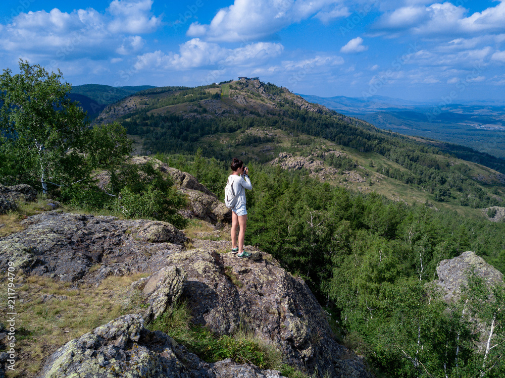 Brave girl standing on the edge of the huge stone Brave girl standing on the edge of the huge stone