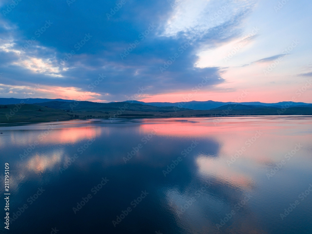 Beautiful panoramic view of the Lake on the sunset and hills on the background