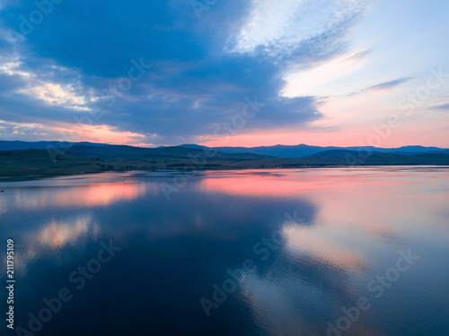 Fototapeta Naklejka Na Ścianę i Meble -  Beautiful panoramic view of the Lake on the sunset and hills on the background
