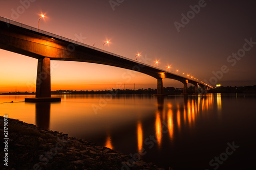 Thai-Laos Friendship Bridge on sunset background © songdech17