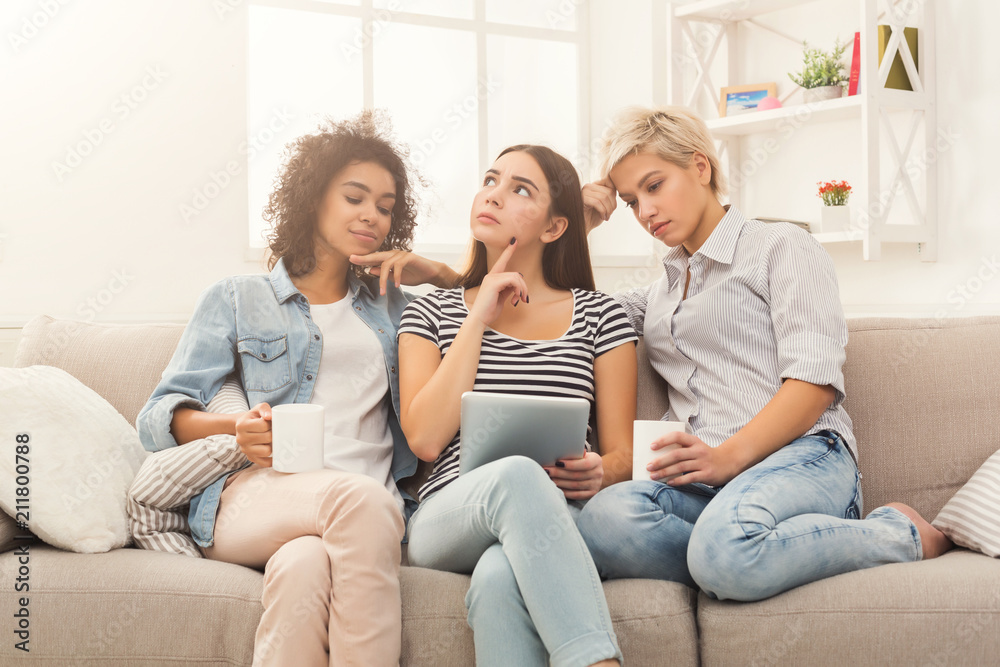 Three friends using tablet and drinking coffee Three friends using tablet and drinking coffee