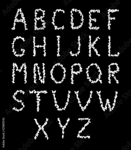 Alphabet from white crumpled pieces of paper on a black background. Isolated.