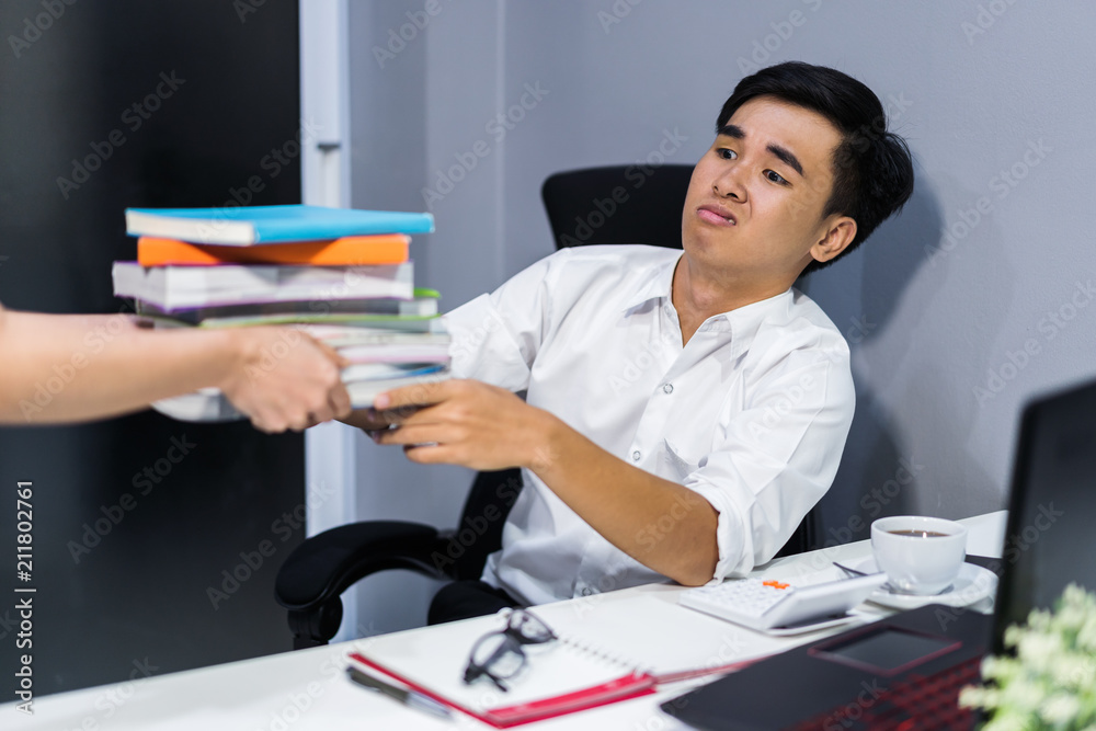 hand giving book to bored student