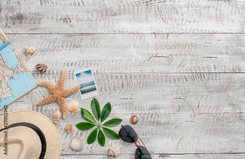 Summer vacation background with copy space,seashells,starfish,map,hat,map and polaroid photo of beach photo