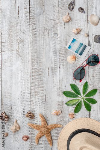 Summer vacation background with copy space,seashells,starfish,map,hat,map and polaroid photo of beach photo