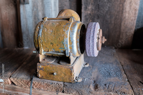 Old grinding machine with wheel in small factory