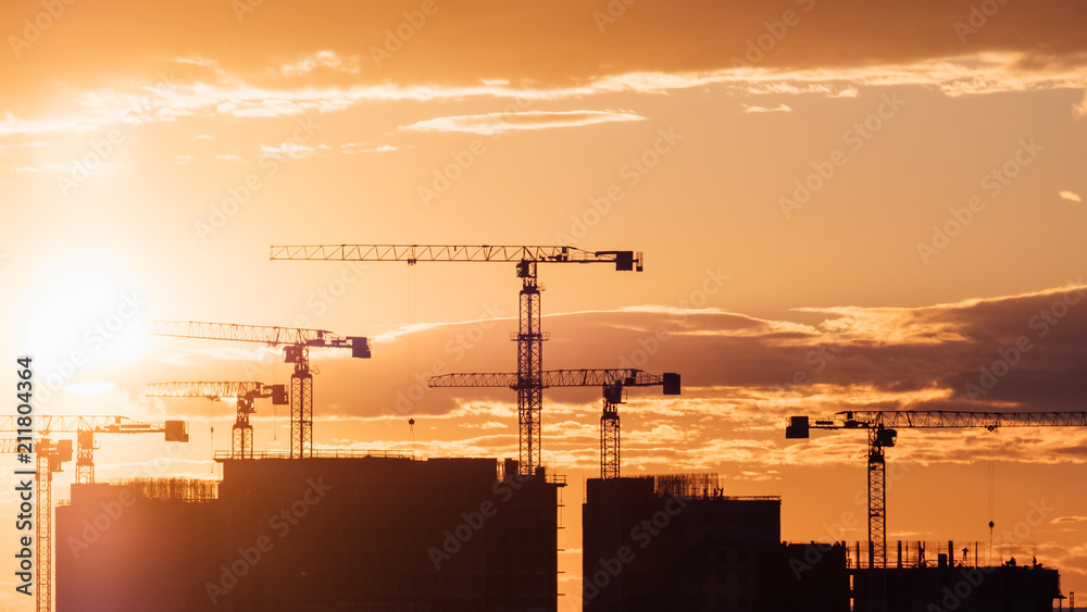 Crane and building silhouettes at sunrise