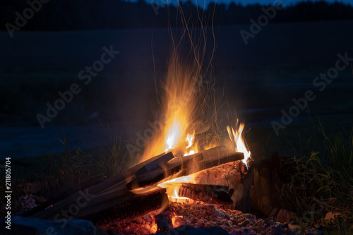 Marshmallows roasting over campfire in the evening