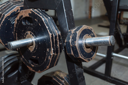 Disassembled barbell on floor in gym.Sports equipment. diverse equipment and machines at the gym room
