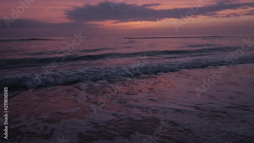 Waves Crashing at Sunset in Slow Motion photo