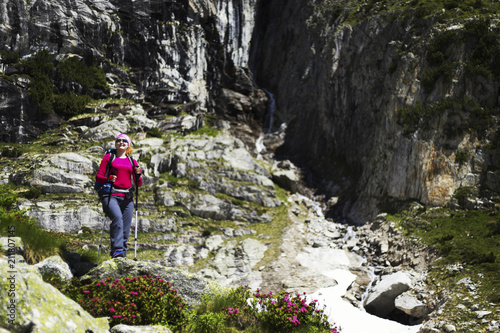 Trek around Mont Blanc. The girl is walking along the trail with a backpack.