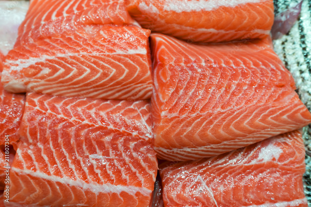 raw pink red salmon fish filets at market