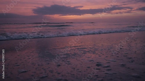 Waves Crashing at Sunset on the Beach - Slow Motion photo