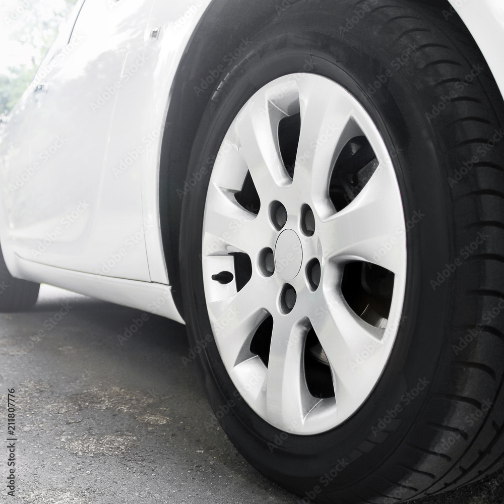 Car wheels close up on a background of asphalt. Car tires. Car wheel close-up.