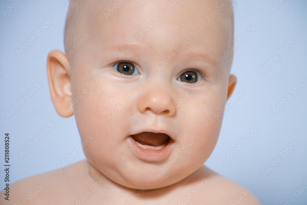 Beautiful close-up portrait of a happy baby on a uniform background Beautiful close-up portrait of a happy baby on a uniform background