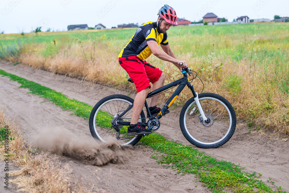 Cyclist riding the bike, a sharp turn on a country road.