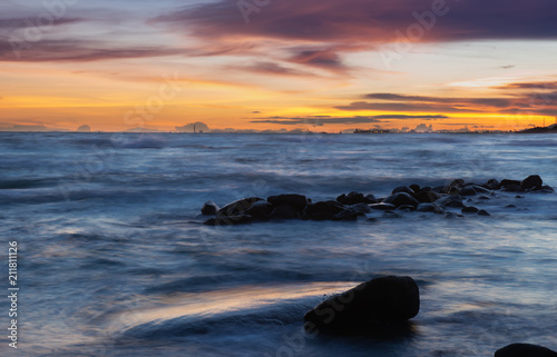 Seascape and rocks in sunset time.