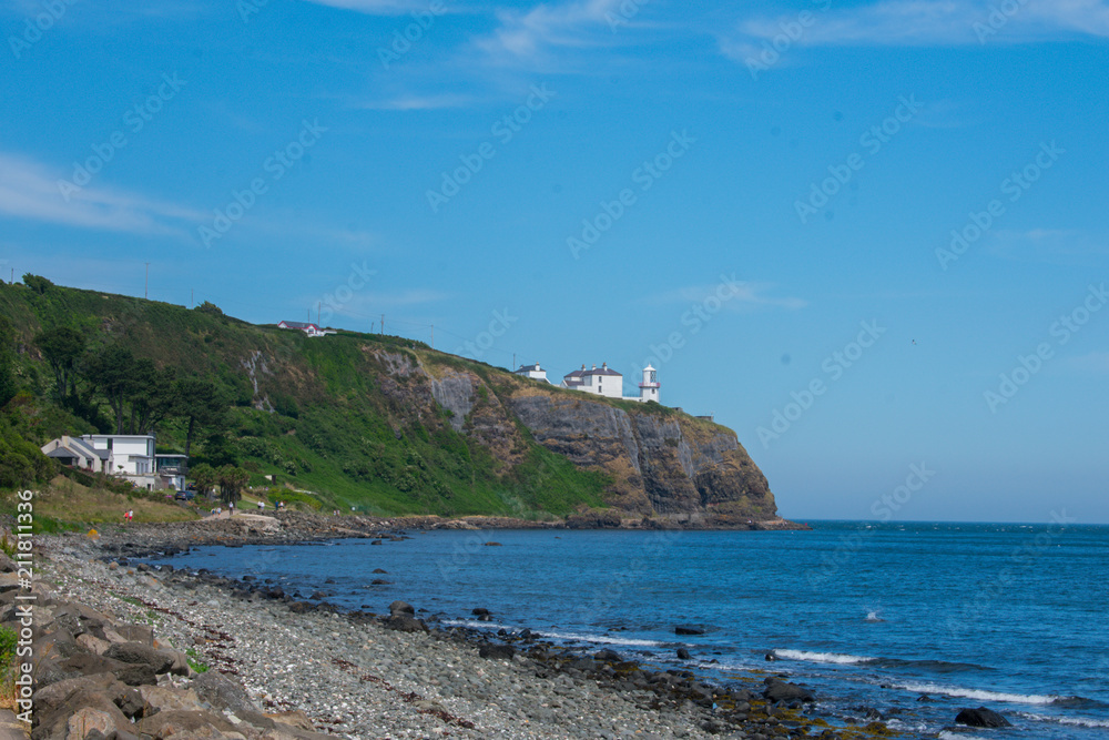 low angle view on lighthouse on edge of cliff in whitehead northern Ireland 