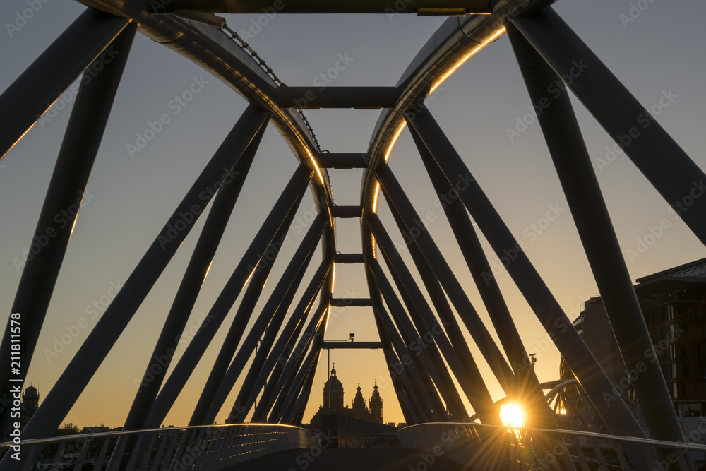 Fototapeta premium Modern bridge over canal at sunset in Amsterdam