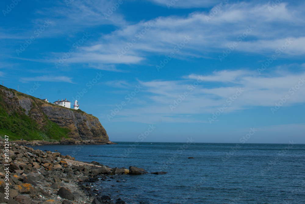 low angle view on lighthouse on edge of cliff in whitehead northern Ireland low angle view on lighthouse on edge of cliff in whitehead northern Ireland
