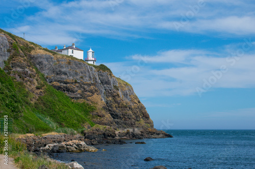 low angle view on lighthouse on edge of cliff in whitehead northern Ireland 