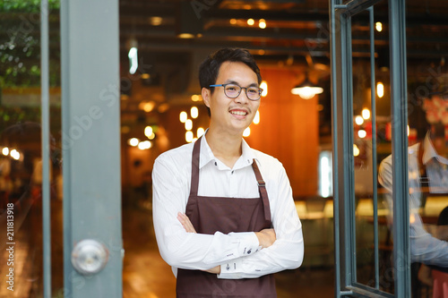 close up business owner barista man standing at cafe for welcome customer 