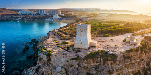 Ghajn Tuffieha, Malta - Beautiful sunrise at Ghajn Tuffieha Watch Tower with Golden Bay beach at background