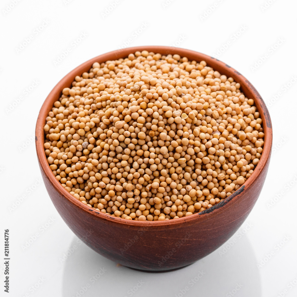 fragrant grains of mustard on a white background fragrant grains of mustard on a white background