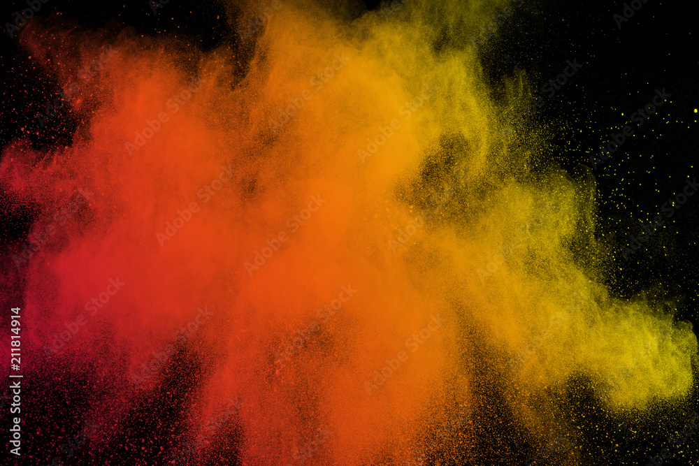 abstract red yellow dust explosion on black background. abstract red yellow powder splattered on  background.