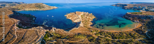 Ghajn Tuffieha, Malta - Aerial panoramic view of the coast of Ghajn Tuffieha with Gnejna Bay, Riviera Bay and Golden Bay at sunrise