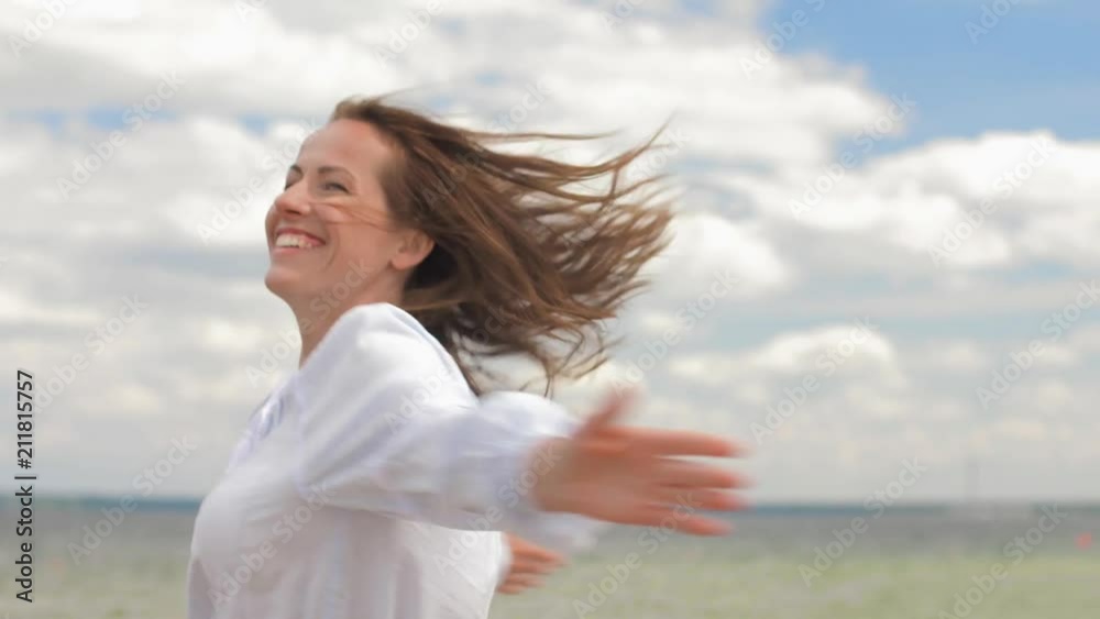 people and leisure concept - happy smiling woman having fun at summer beach