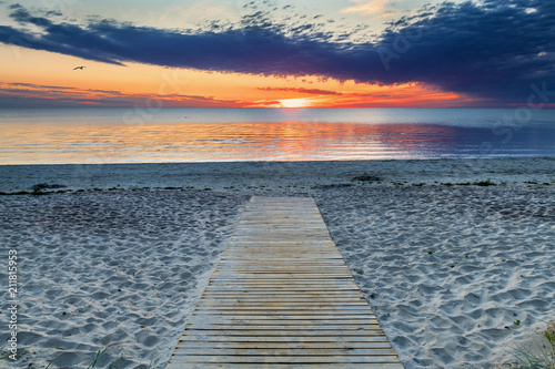 Fototapeta Naklejka Na Ścianę i Meble -  Scenic view on sandy beach of the Baltic Sea during colorful sunrise