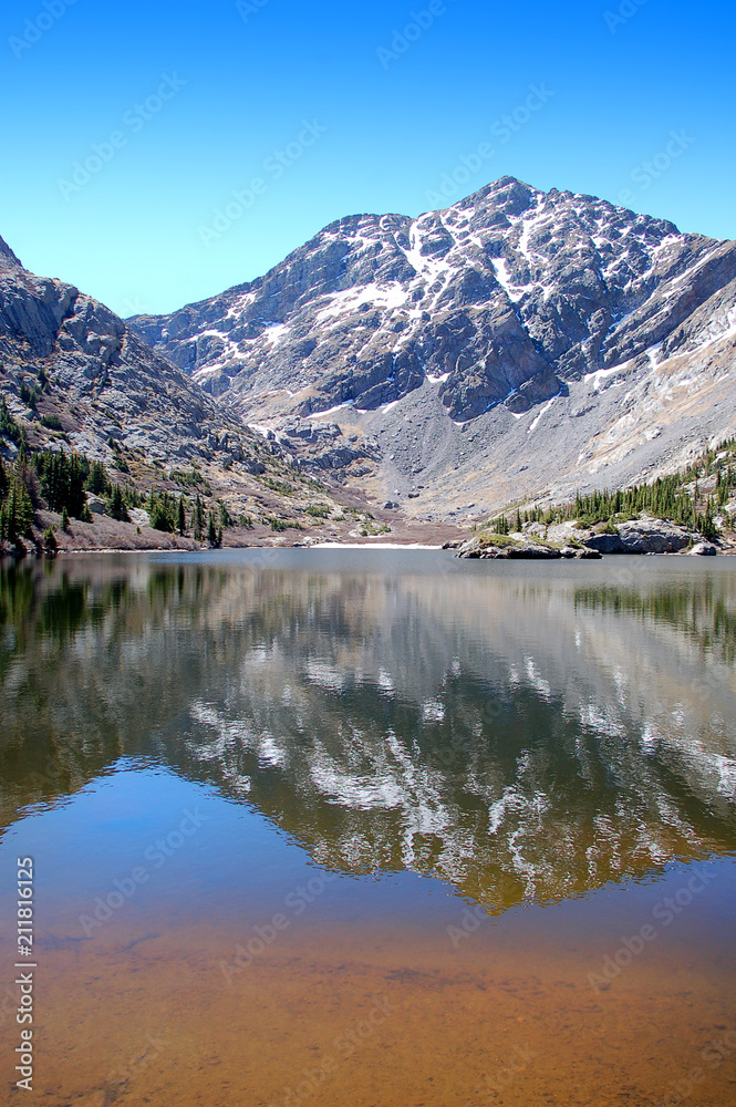  Craggy 14000 foot mountain peaks reflected in the waters of South Crestone lake in the Sangre De Cristo Mnts of Southern Colorado.