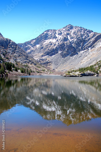  Craggy 14000 foot mountain peaks reflected in the waters of South Crestone lake in the Sangre De Cristo Mnts of Southern Colorado.