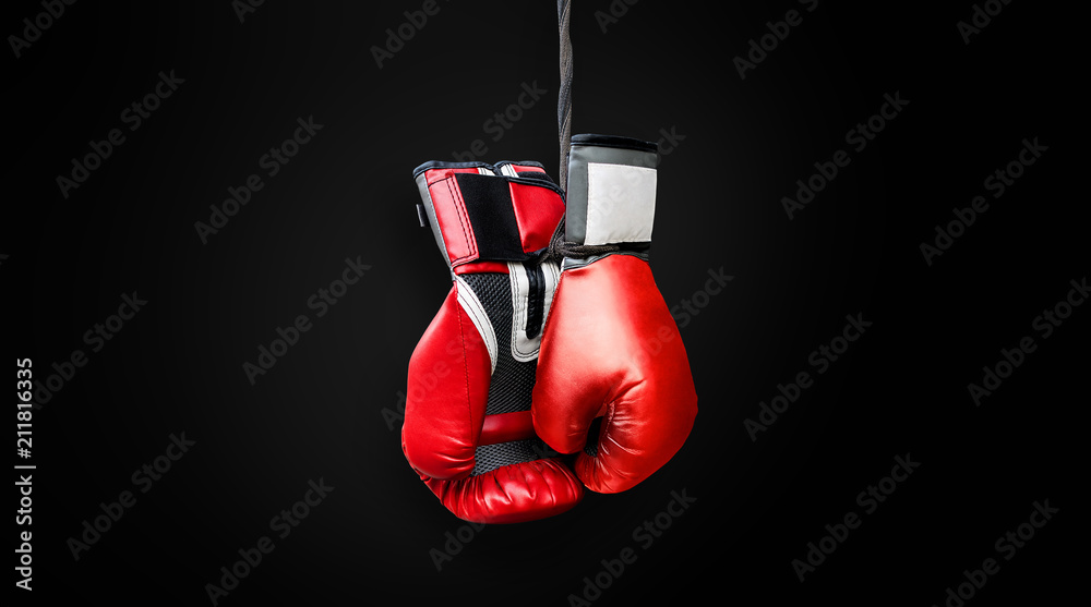 Red black grey boxing gloves hanging and ready to be used in the fight