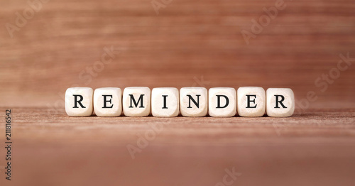 Word REMINDER made with wood building blocks photo