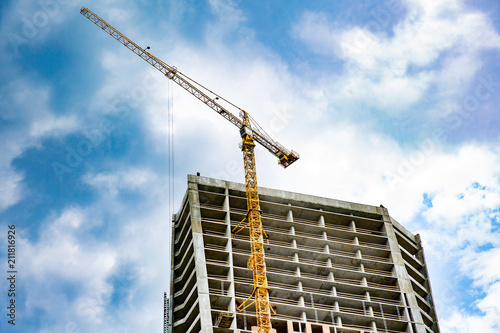 Skyscraper construction. Tower crane over construction building.