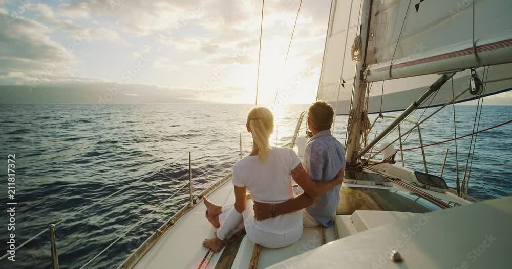 Retired middle aged couple sailing into the sunset