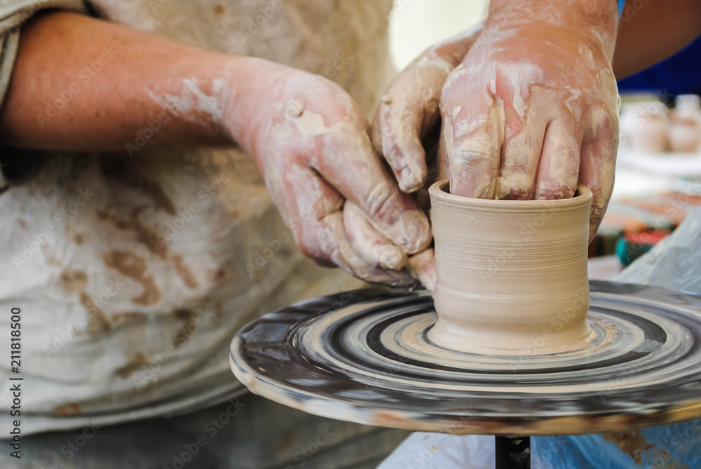 Hands and a potter's machine Hands and a potter's machine