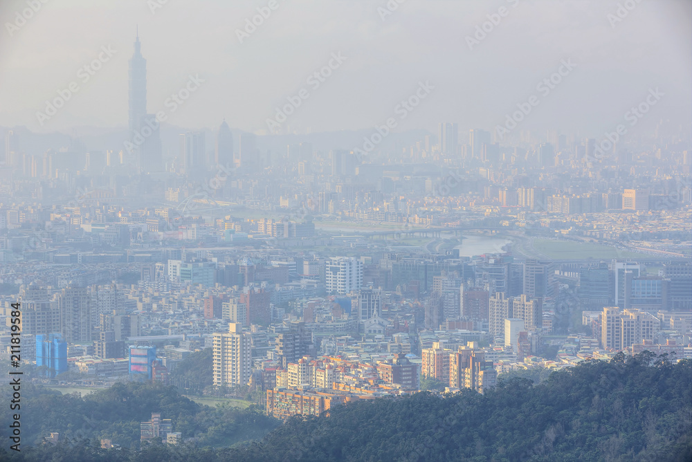 Aerial view of Taipei 101 tower in XinYi District, and Keelung River, capital city of Taiwan, with heavily polluted air on a hazy winter day ~ Air pollution level of PM2.5 classified as 