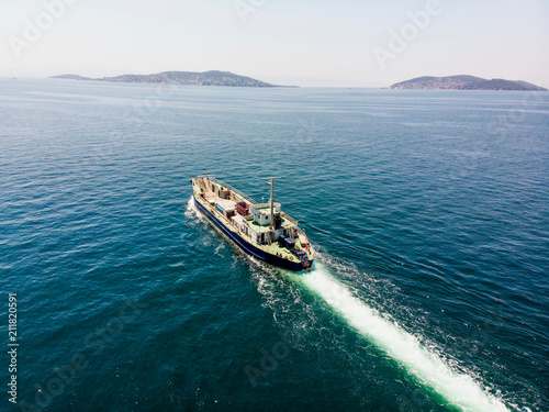 Aerial Drone View of Cargo Ship Carry Vehicles to the Island. © Alp Aksoy