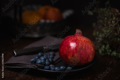 Pomegranate on a Plate with Blueberries