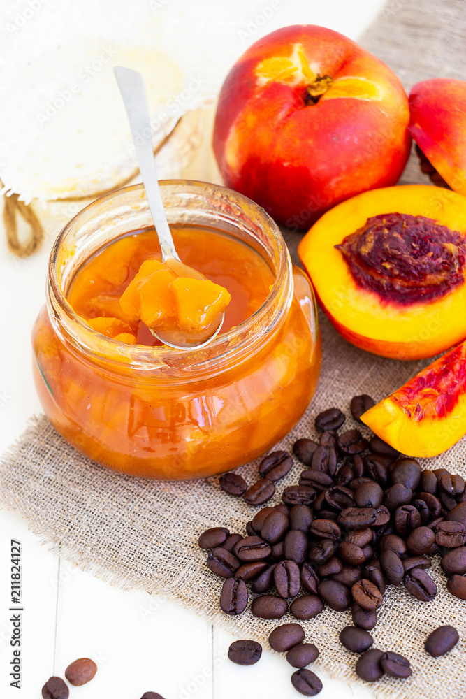 Nectarine jam confiture in ramekin and jar. Dark background. Selective focus. Close up. Nectarine jam confiture in ramekin and jar. Dark background. Selective focus. Close up.