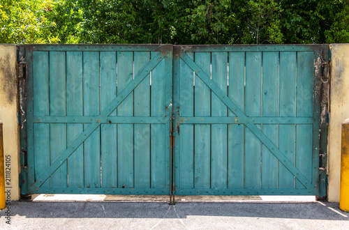 Wallpaper Mural Wooden gate doors with rusted metal frame, painted blue green - Davie, Florida, USA Torontodigital.ca