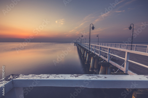 Amazing colorful sunrise over the pier in Gdynia Orlowo. Sunrise over the sea.