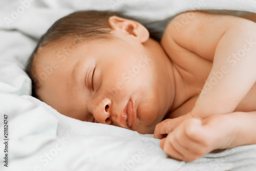 Portrait of a sleeping newborn baby sleeping on his side