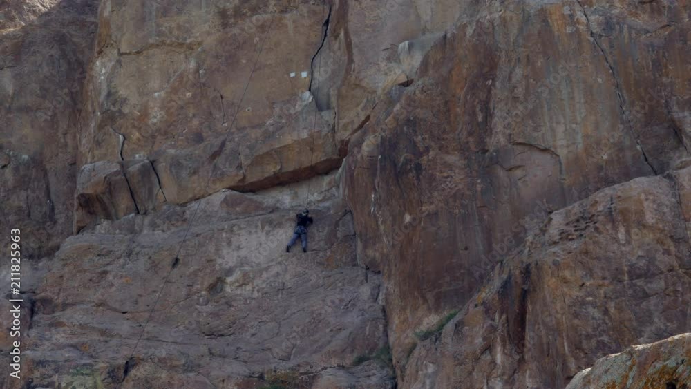 Man climber hiking and climbing the rock Man climber hiking and climbing the rock