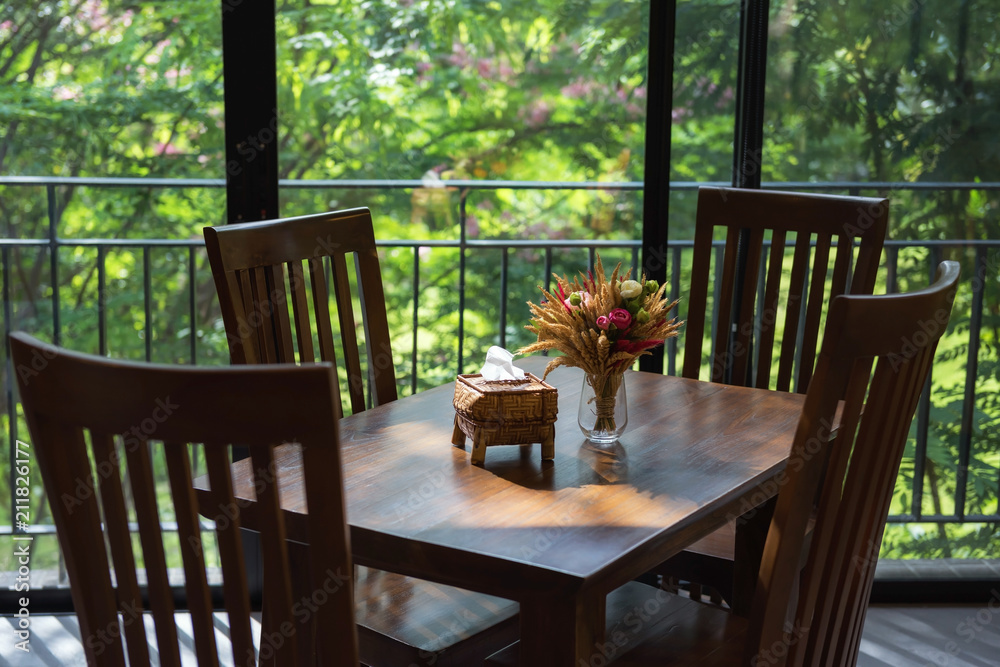 Fototapeta premium dinning table and flower with greenery view