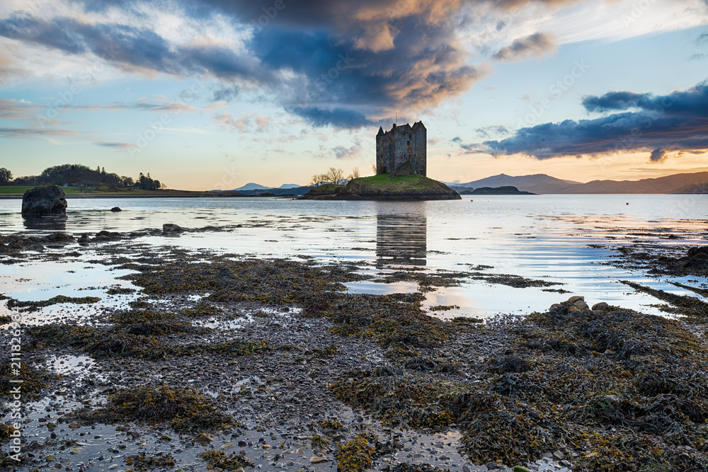 Dramatic sunset over Castle Stalker on an isle in Loch Linnhe in the Highlands of Scotland